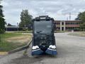 A 2019 Madvac LS175 street sweeper with large blue brushes at the front and a clear view of the cabin and controls inside