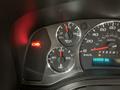 Dashboard of a 2015 Chevrolet Express showing speedometer fuel gauge and warning lights