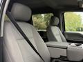 Interior of a 2020 Ford F-550 showing two gray cloth seats and a center console