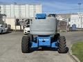 A blue 2012 Genie Z 45/25 aerial work platform with large rubber tires and a grey control box on the back