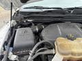 A 2016 RAM 1500 engine with visible components including the air intake and coolant reservoir