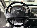Steering wheel of a 2011 International 4300 featuring various controls and a dashboard with gauges and displays
