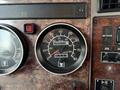 Dashboard of a 2008 Kenworth T370 showing an analogue speedometer with a reading of 0 kilometers per hour and a total mileage of 880227 miles