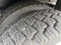 Close-up of the tread on a tire from a 2012 International TerraStar showcasing worn rubber and deep grooves designed for traction