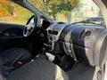 Interior view of a 2012 Mitsubishi I-MiEV showing the dashboard gear shift and seating area