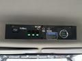 Control panel of a 2015 Freightliner M2 featuring switches and indicators for body functions and oil temperature display