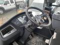 Interior view of a 2016 Hyundai HL940 construction vehicle showcasing the steering wheel control panel and dashboard instruments