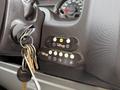 Control panel of a 2009 Ford Econoline featuring buttons for an advanced fast file system and an intelligent lift interlock system along with a set of keys