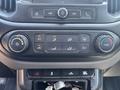 The control panel of a 2017 Chevrolet Colorado featuring climate control buttons for air conditioning fan speed and temperature adjustment