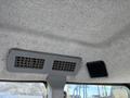 Interior view of a 2010 New Holland T4050 showcasing ceiling vents and an audio speaker