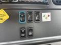 Dashboard controls of a 2016 Freightliner 108SD featuring various switches for light tests and options along with an alarm indicator and a parking brake release