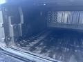 The image shows the interior cargo area of a 2011 Chevrolet Avalanche with a rubber floor and textured sides