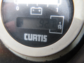Close-up of a Curtis gauge displaying a reading of 92.0 on a digital meter