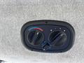 Control panel for climate settings featuring two knobs for temperature and fan speed along with a switch for air circulation