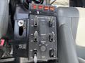 Control panel of a 2015 Ford F-750 featuring multiple switches for various functions including master air and directional controls
