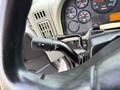 Close-up of the steering wheel and control stalk of a 2014 International TerraStar showing various dashboard gauges and controls