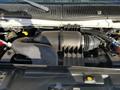 Engine compartment of a 2014 Ford Econoline showcasing the air intake and various components