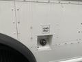 A close-up view of the gas filler opening on a 2012 Ford Econoline with a sticker that reads GAS ONLY