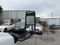 A 2014 Ford E-350 van is parked with its side mirror reflecting nearby vehicles in a parking lot