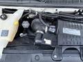 A 2019 Chevrolet Express engine compartment showing the air intake system with a black plastic housing and various hoses and connectors