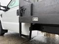 A 2008 Ford F-350 with a black flatbed attachment showing a metal frame and a mounted label for the manufacturer