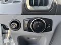 Dashboard controls of a 2016 Ford Transit 150 featuring light control dial and switch for the door unlock function