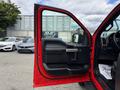 A 2019 Ford F-150 with the driver's side door open showcasing the interior features and controls