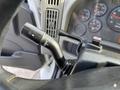 A close-up of the signal and wiper control lever inside a 2012 International DuraStar 4300 truck's cabin