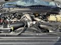 The engine compartment of a 2022 Ford F-550 showcasing various components including hoses wires and the engine block