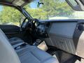Interior of a 2011 Ford F-550 featuring gray seats and a dashboard with controls and a display screen