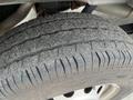 A close-up view of a worn tire from a 2023 Ford Transit showing tread patterns and surface wear