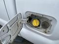 A yellow fuel cap is visible inside the opened fuel door of a 2015 Ford F-250 SD