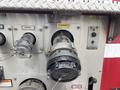 A close-up view of a discharge valve from a 2006 E-One Typhoon fire truck showing labels and a secured handle
