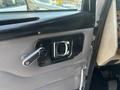 The interior door handle of a 2008 Peterbilt 340 featuring a chrome lever and rectangular bezel on a textured grey panel