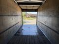 Interior view of a 2012 Freightliner M2 106 truck trailer showing wooden walls and a flat floor with visible tire tracks