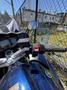 A close-up view of the handlebar controls and mirror of a 2016 Yamaha FJR1300AE motorcycle