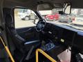 Interior view of a 2014 Chevrolet Express showing the driver's seat dashboard steering wheel and controls