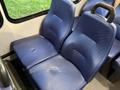 Two blue bench seats with a textured surface designed for passenger comfort in a vehicle interior