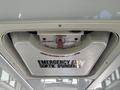 Emergency exit hatch of a 2020 Chevrolet Express with a knob to turn and push for opening marked with instructions in English and French
