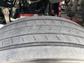Close-up of a tire from a 2022 Freightliner M2 106 showing worn tread with visible grooves and minor debris embedded in the rubber
