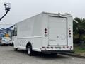 2012 Ford E-450 Super Duty white delivery van with a roll-up rear door and red brake lights