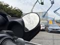 A 2009 Harley-Davidson Road King with a chrome side mirror prominently displayed reflecting part of the surroundings