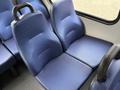 Two blue fabric seats with ergonomic shapes sit side by side in a vehicle interior