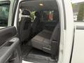 Interior view of a 2013 Chevrolet Silverado 3500HD showing the rear seats and door panel of the crew cab design