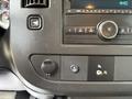 Dashboard controls of a 2018 GMC Savana including buttons for power, audio settings and climate control