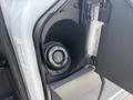 Close-up of the fuel door on a 2016 Ford Transit 150 showing the fuel cap labeled Easy Fuel and the opening for refueling