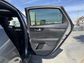 A 2024 Kia Forte5 with the driver's side door open showcasing the interior design and controls