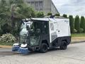 A 2019 Madvac LS175 urban cleaning unit featuring three large brushes at the front and a streamlined, compact body design in white and black colors