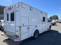 A 2013 Chevrolet Express van designed for emergency services with a large white body and multiple windows on the side and rear