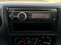 A vehicle stereo system with a display showing FM radio frequency 8709 and various control buttons for radio and air conditioning settings